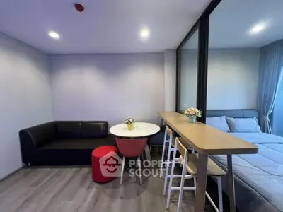 Modern studio apartment with cozy living area and stylish furnishings