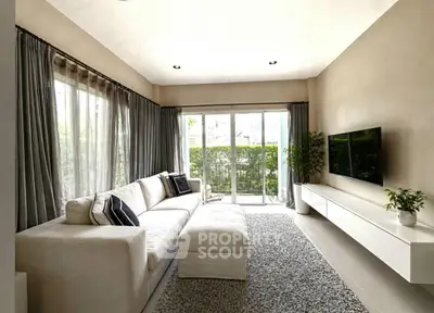 Spacious modern living room with large windows and elegant decor
