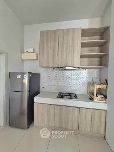Modern kitchen with sleek cabinetry and gas stove in contemporary apartment