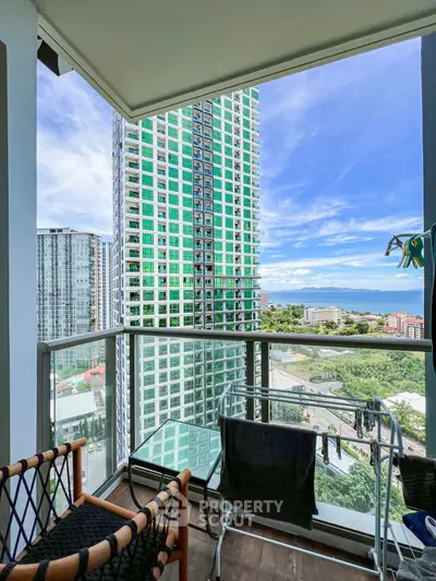 Stunning balcony view with modern high-rise buildings and scenic landscape.