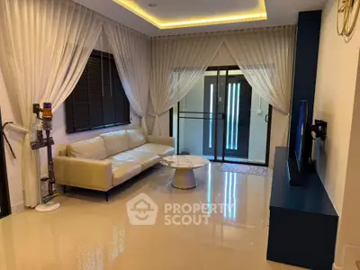 Elegant living room with modern decor, featuring a sleek sofa, stylish curtains, and a contemporary TV setup.