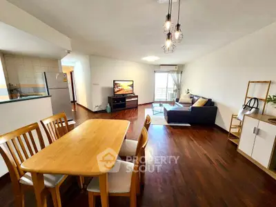 Spacious open-plan living room with modern furnishings and wooden flooring