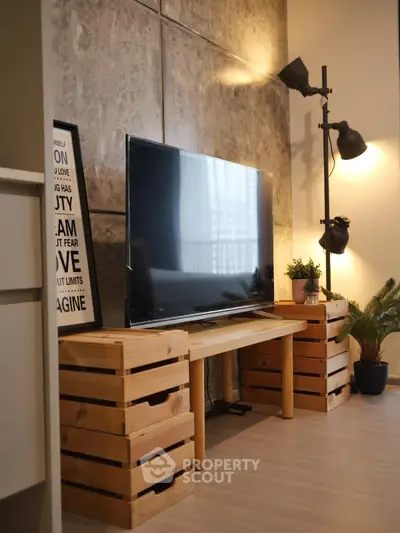 Stylish living room with modern TV setup and industrial lighting
