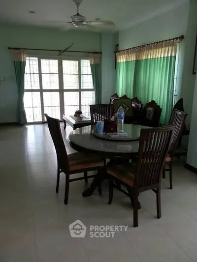 Spacious dining area with natural light and elegant wooden furniture