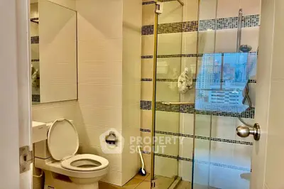Modern bathroom with glass shower and city view window