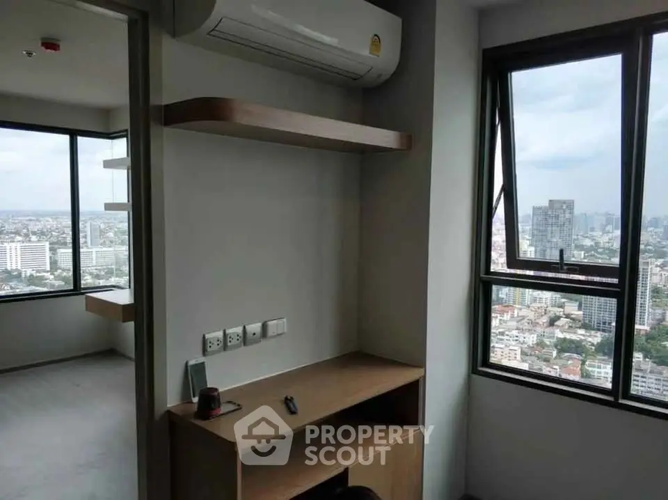 Modern high-rise apartment with stunning city view and sleek interior design.