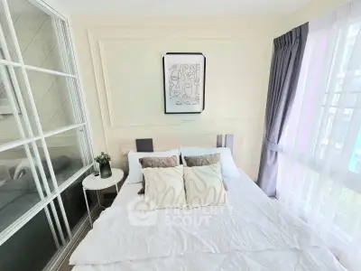 Cozy bedroom with modern decor and large window for natural light