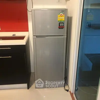 Modern kitchen with sleek fridge and stylish cabinetry