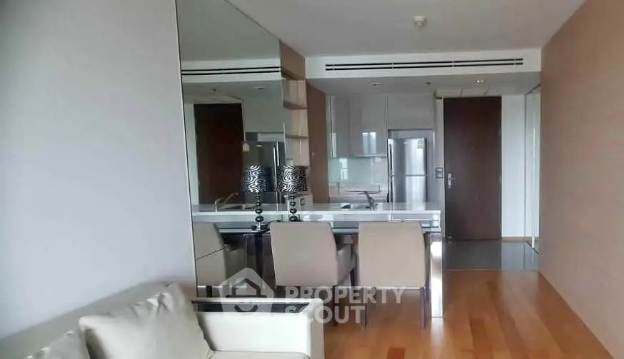 Modern living room with sleek dining area and stylish decor in a contemporary apartment.