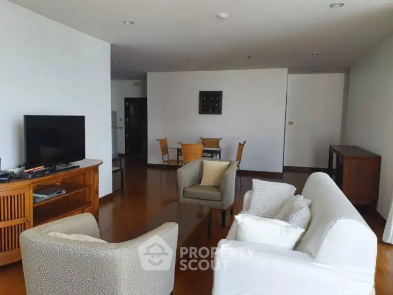 Spacious living room with modern furniture and wooden flooring