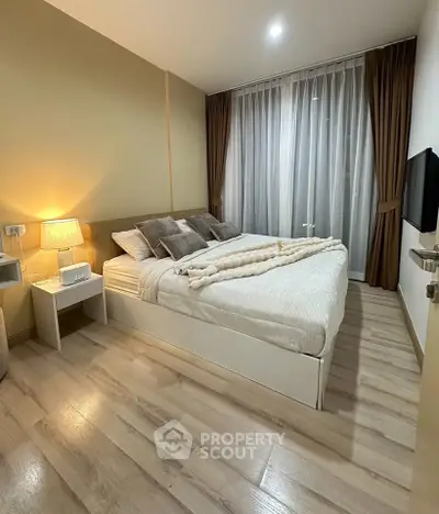 Cozy modern bedroom with elegant decor and soft lighting, featuring a comfortable bed and stylish curtains.