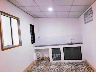 Modern minimalist kitchen with sleek countertops and tiled flooring