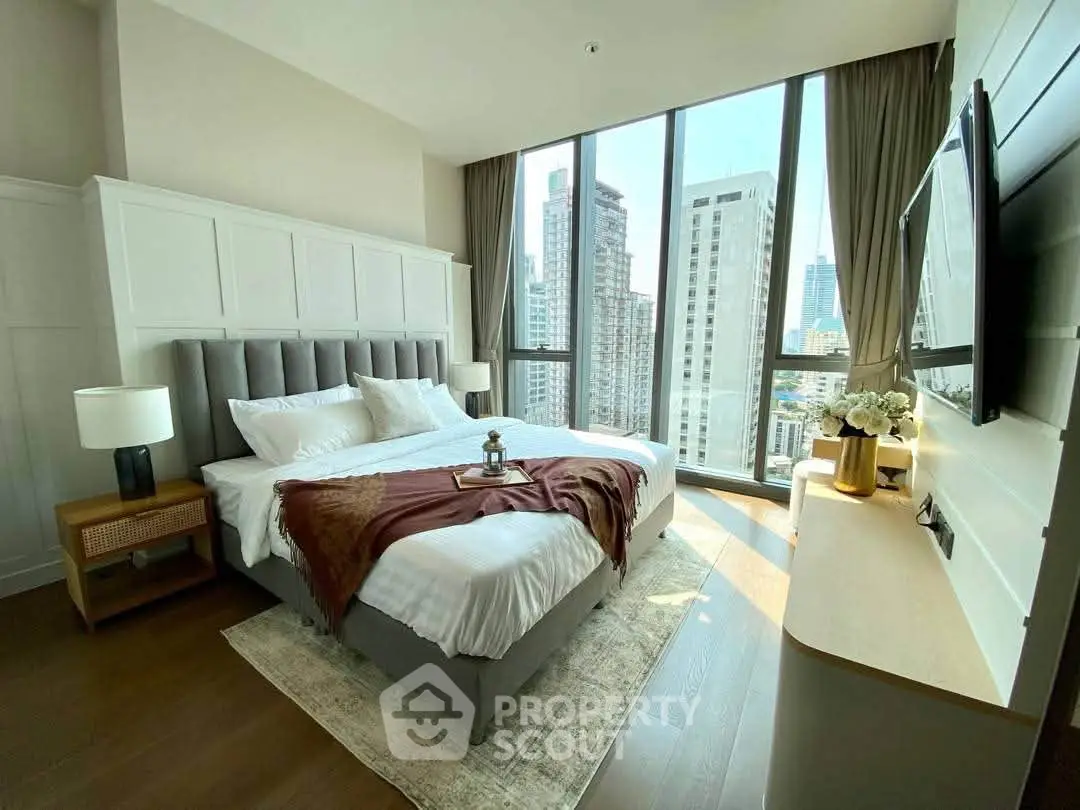 Luxurious bedroom with floor-to-ceiling windows offering stunning city views in a modern high-rise apartment.