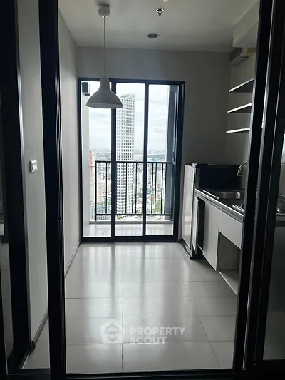 Modern kitchen with city view and sleek design in high-rise apartment