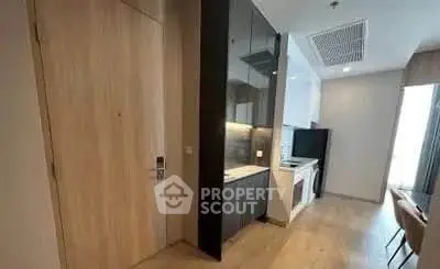 Modern apartment entrance with sleek kitchen and open layout