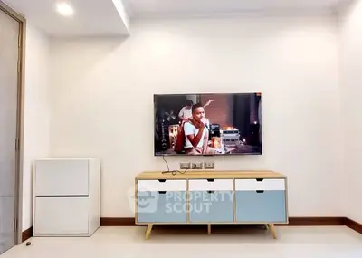 Modern living room with sleek TV setup and stylish storage unit