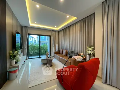 Modern living room with stylish decor and garden view, featuring cozy seating and elegant lighting.