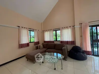 Spacious living room with high ceiling and modern furniture