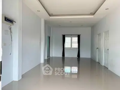 Spacious empty room with glossy tiled floor and window, ideal for customization.