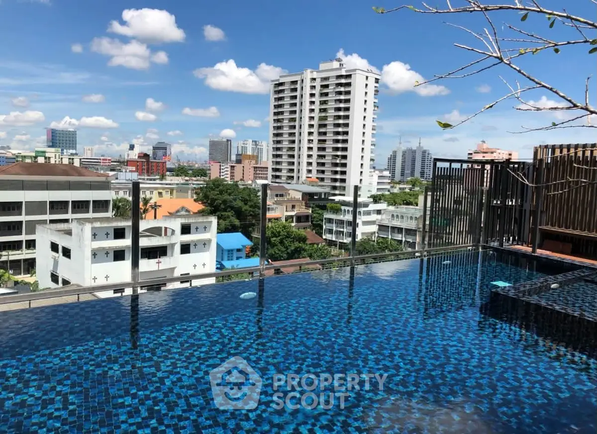 Stunning rooftop pool with panoramic city views in a modern urban setting.