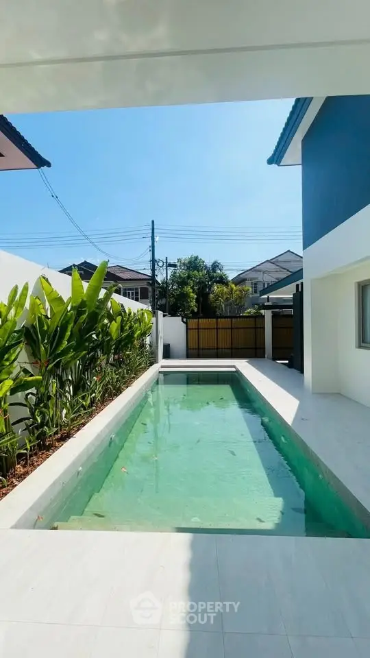 Modern residential property with sleek pool and lush greenery, perfect for luxury living.
