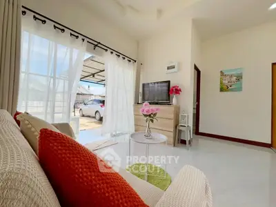 Bright and airy living room with modern decor and large windows.