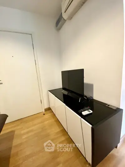 Modern living room corner with sleek TV stand and air conditioning