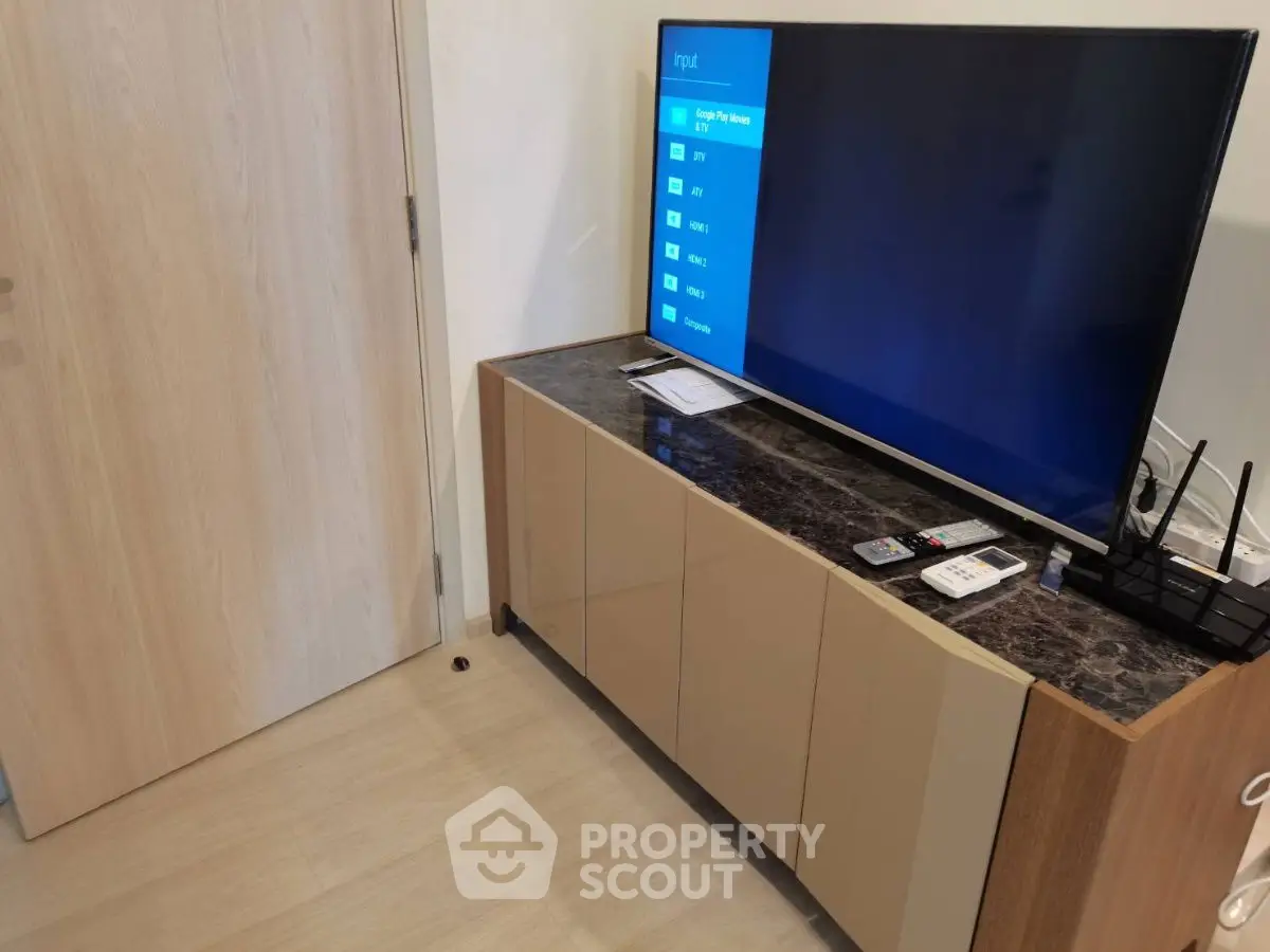 Modern living room with sleek TV setup and stylish cabinet