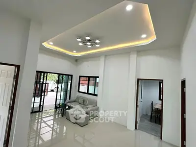 Spacious modern living room with stylish ceiling lights and large windows