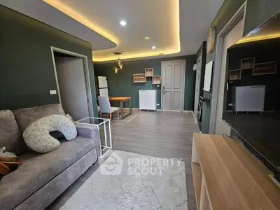 Modern living room with stylish decor and open layout, featuring cozy sofa and dining area.
