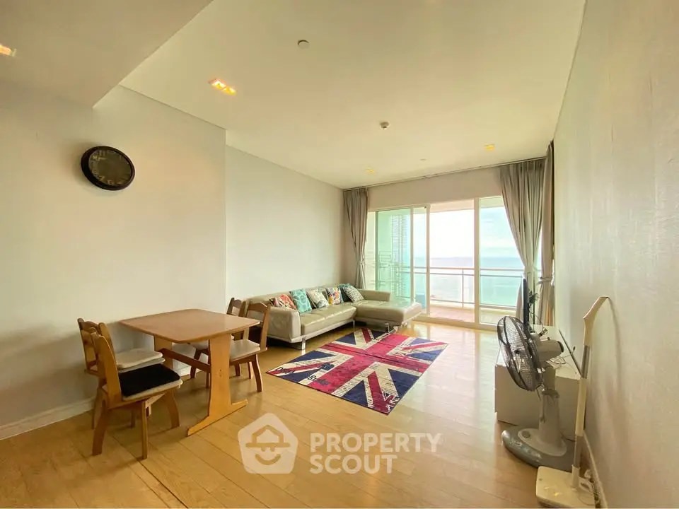 Spacious living room with modern decor and balcony offering stunning views