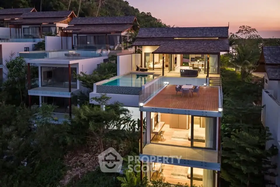 Luxurious modern villa with stunning sunset view, private pool, and spacious terrace in tropical setting.
