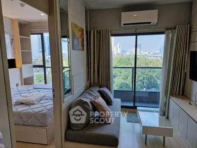 Modern apartment with city view, featuring cozy living room and bedroom, ideal for urban living.