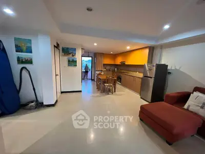 Spacious open-layout kitchen and living area with modern appliances and cozy seating.