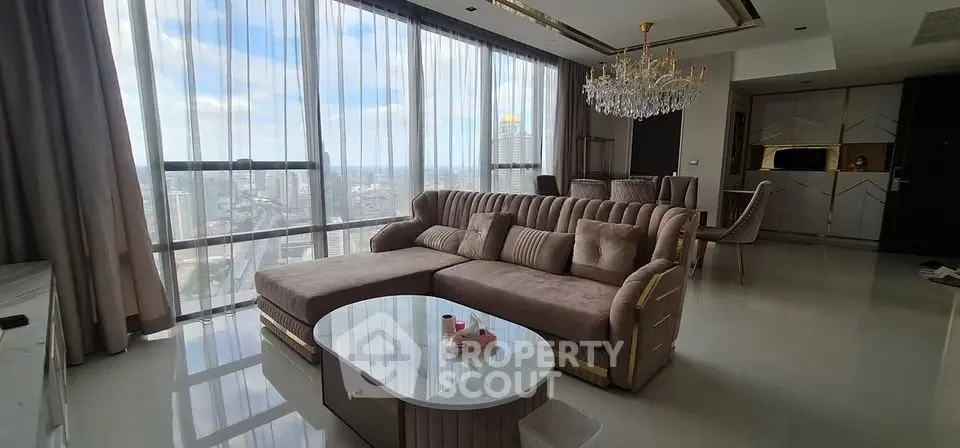 Luxurious high-rise living room with panoramic city views and elegant decor.