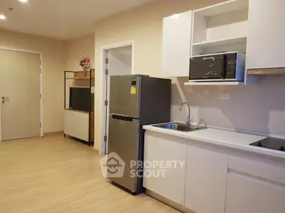 Modern kitchen with sleek appliances and open layout in a stylish apartment.