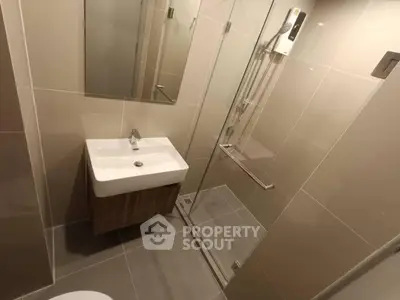 Modern bathroom with sleek shower and stylish sink in contemporary design.