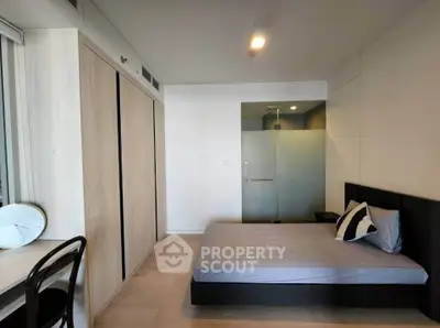 Modern bedroom with sleek design, featuring a comfortable bed, built-in wardrobe, and stylish decor.