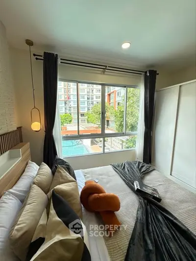 Luxurious bedroom with pool view and modern decor in urban apartment