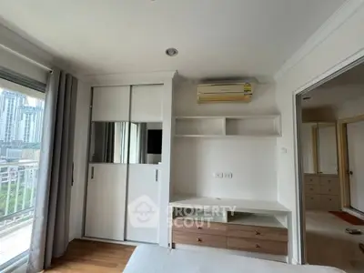 Modern bedroom with built-in wardrobe and city view from window