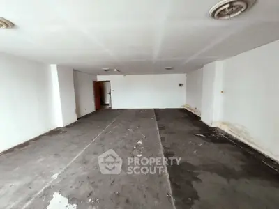 Spacious unfinished room with potential for customization in a real estate property.