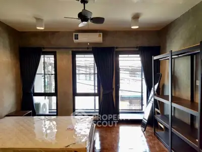 Spacious bedroom with large windows and modern decor