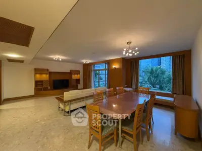 Spacious living room with elegant dining area and large window view.