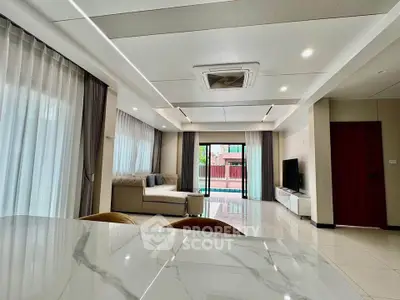 Spacious modern living room with elegant decor and large windows for natural light.