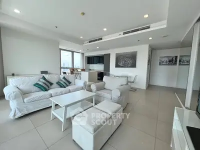 Spacious modern living room with white furniture and city view, perfect for urban living.