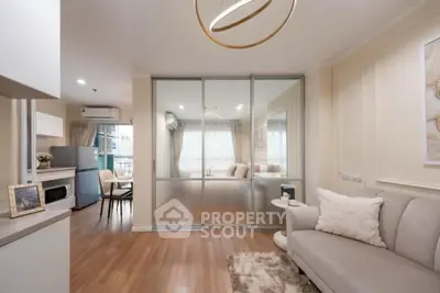 Modern living room with elegant decor and sliding glass doors leading to a cozy dining area.