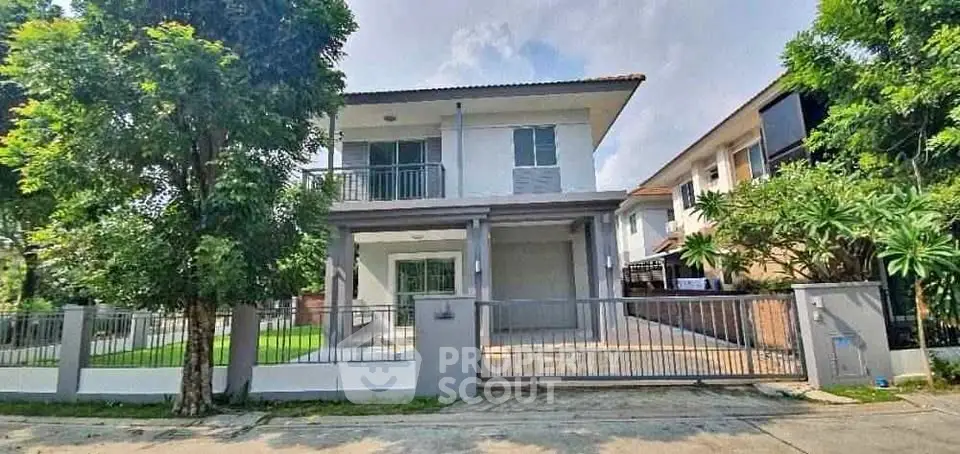 Modern two-story house with lush greenery and spacious driveway