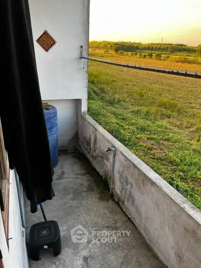 Charming rustic balcony with countryside view, perfect for relaxation and enjoying nature's tranquility.
