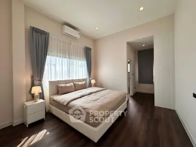 Spacious modern bedroom with elegant decor and natural light