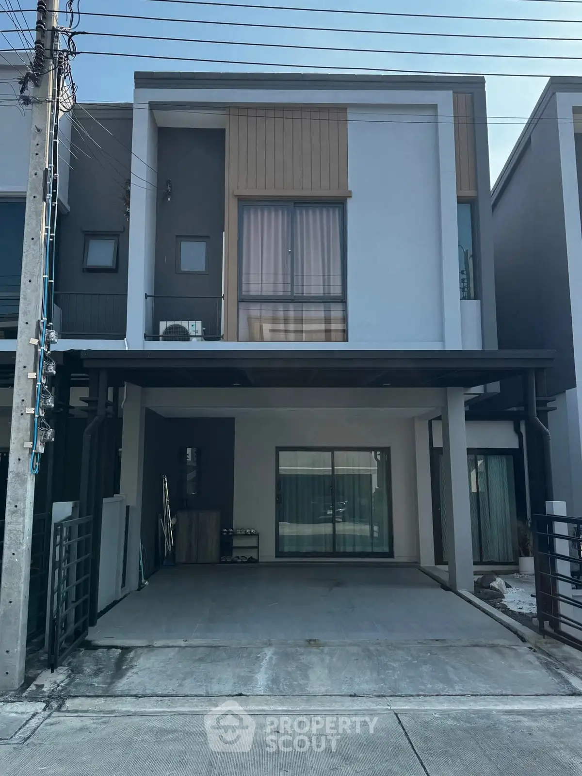Modern two-story townhouse with covered parking and sleek facade
